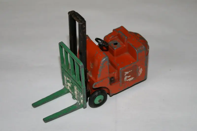 A worn orange Dinky Toys fork-lift truck — an example of 1960s Dinky die-cast (not a Thunderbirds model)