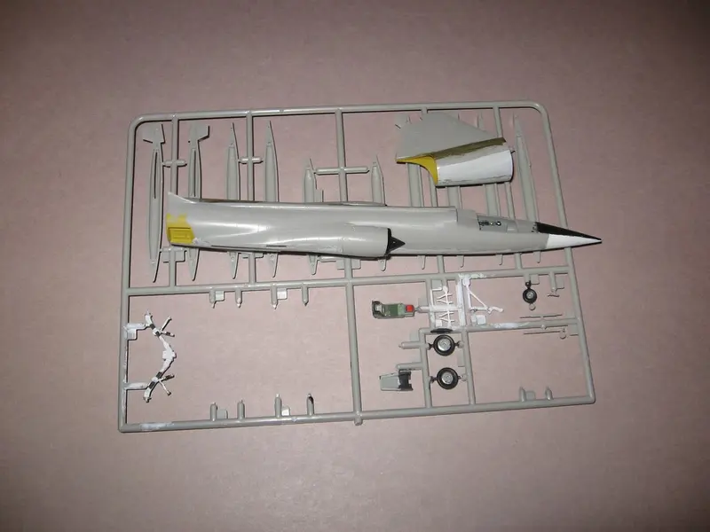 Grey plastic kit parts still attached to the sprue frame (a jet aircraft kit, shown as a general example)