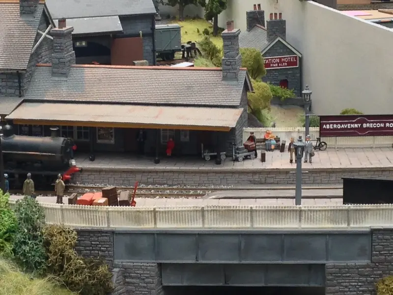 Detailed model railway station layout on display at a toy and collectors fair